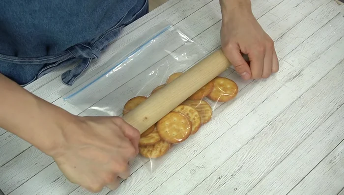 Prepare the cracker base: Crush crackers into fine crumbs. Melt butter in the microwave and mix with the crumbs until well combined.