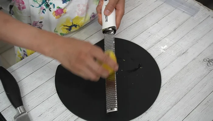 Grate the zest from half a lemon.