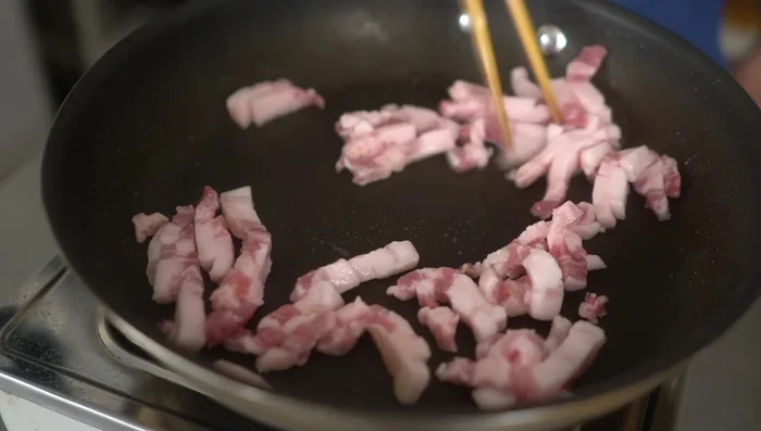 Fry the pork belly: Fry the pork belly strips in the same pan thoroughly until cooked through and slightly crackling.