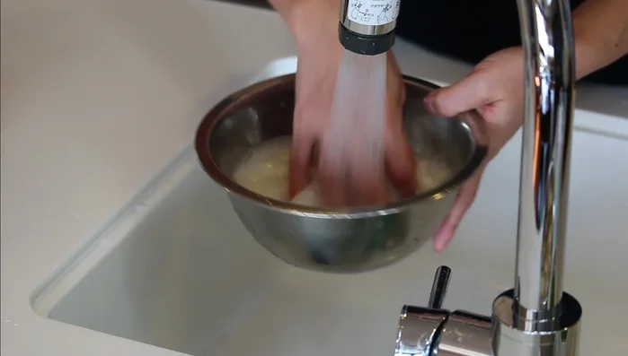 Rinse the rice three to four times until the water runs clear.