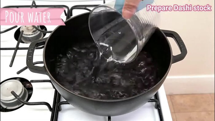 Rinse the cooked udon noodles under cold water to stop the cooking process and cool them down.