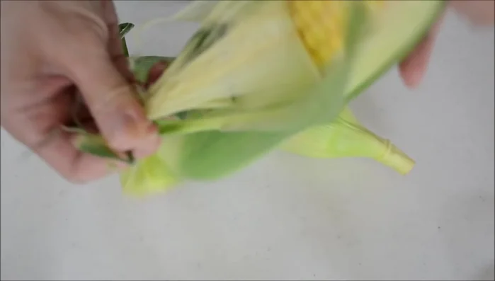 Peel back the corn husks and remove the silk. [34.64]