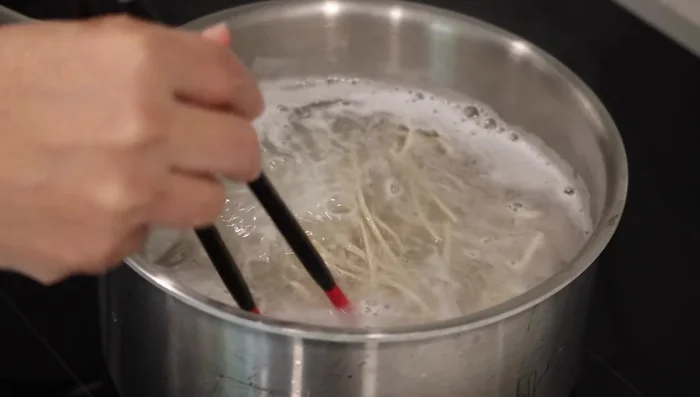 Cook dried soba noodles according to package directions. Strain, rinse under cold water, and cool thoroughly. Then, strain well and set aside.