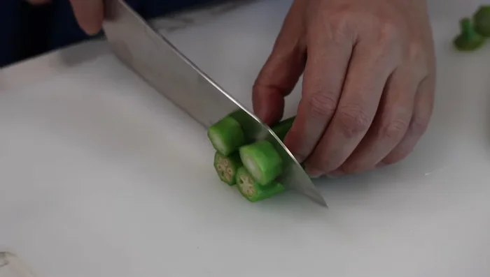 Blanch okra and cut into halves (approximately 2 inches in length).