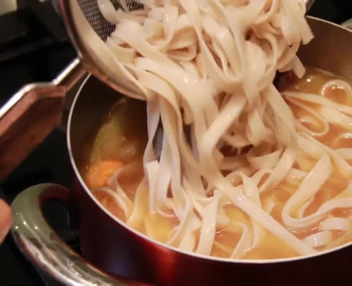 Add the drained udon noodles to the pan, stir and cook for 1-2 minutes until heated through.