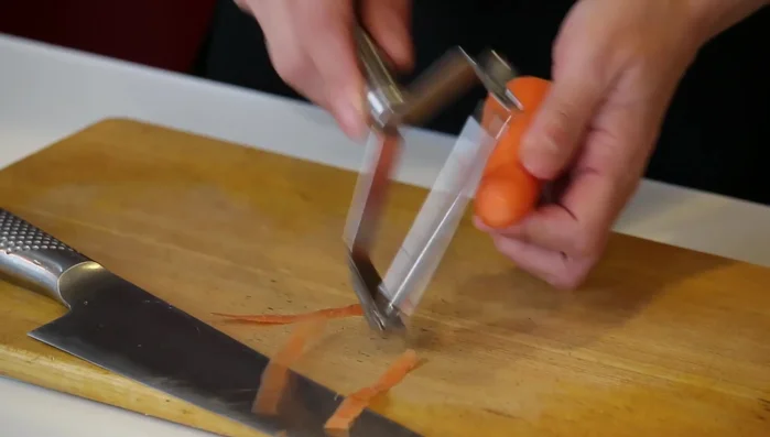 Prepare the vegetables: thinly slice the carrot into diamond shapes and then into thin strips. Slice the cucumber into thin diagonals.