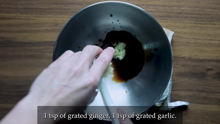 Prepare the marinade: In a bowl, mix soy sauce, ginger, garlic, sake, and sesame oil. Add chicken pieces, ensuring even coating. Cut chicken against the grain into similar-sized pieces.