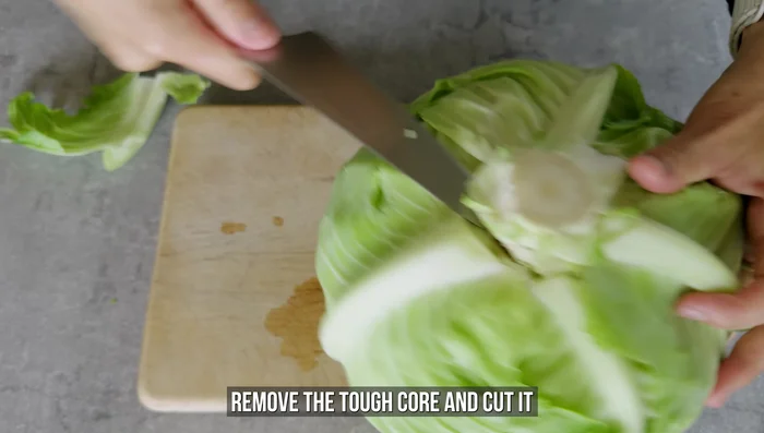 Prep the cabbage: Remove the core and cut into quarters.