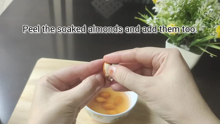 Peel the soaked almonds and grind them with the rice paste.