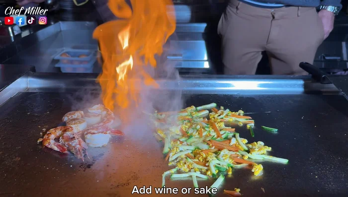 Add wine or sake and lemon juice to the seafood.