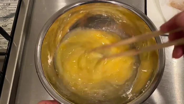 Make tempura batter, coat prawns in flour, then dip in batter and fry until crisp. Add more batter while frying.