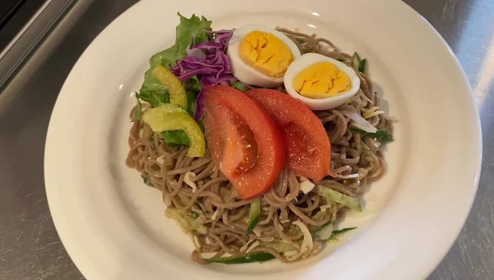 Soba Salad: Make the dressing: combine peanut butter, vinegar, soy sauce, sesame oil, honey, and lemon juice. Stir well. Cook soba noodles. Mix noodles with shredded cucumber and cabbage, and the dressing. Add toppings like lettuce, tomato, and boiled egg.