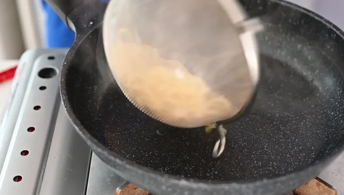 Drain the spaghetti and return it to the frying pan. Add half-and-half and the prepared tarako.