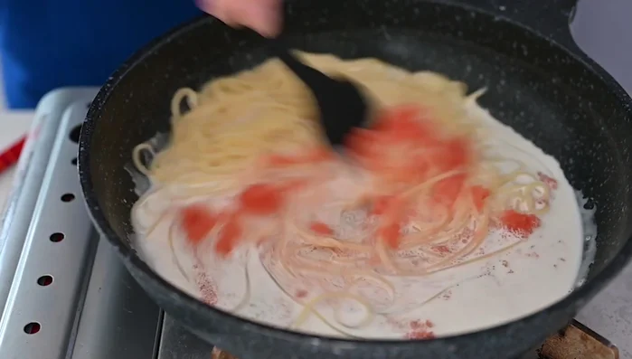 Cook over medium-high heat until the spaghetti absorbs the creamy sauce and the sauce reduces (about one minute).