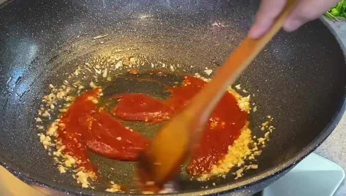 Add tomato sauce, water, sugar, chopped tomatoes, pineapple, and cucumber. Bring to a boil, then reduce heat and simmer for 1-2 minutes. Add salt.