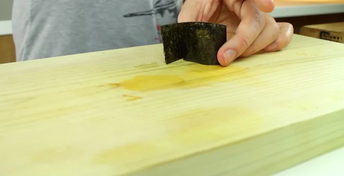 Seal the nori by pressing a few grains of rice along the seam.