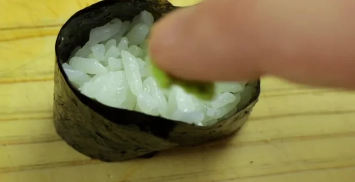 Add a small amount of wasabi to the inside of the rice roll.