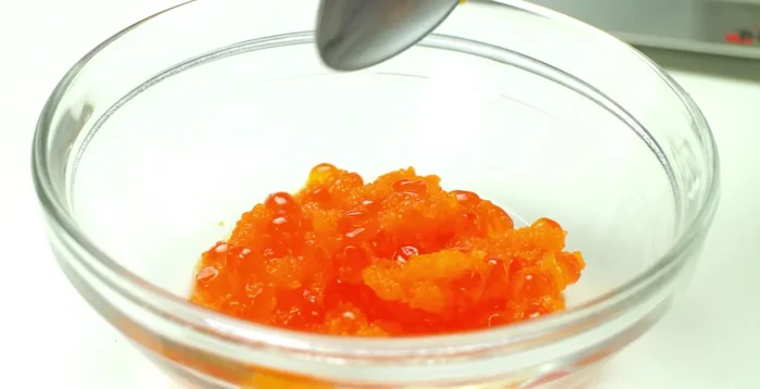 Fill the roll generously with the salmon roe and masago mixture.