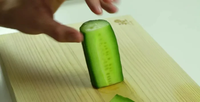 Cut thin, off-center slices of cucumber to avoid the seeds. Arrange three slices together.