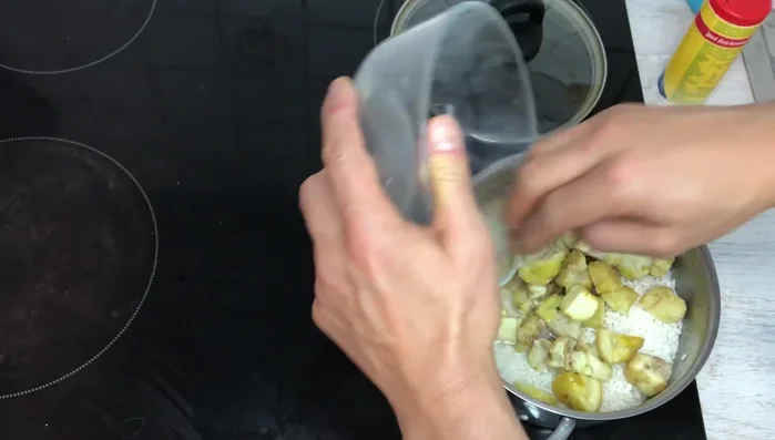 Add the peeled chestnuts to the rice, spreading evenly. Cover the pot.