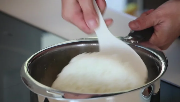 Fluff the cooked rice with a rice paddle or fork. Let it cool to lukewarm.