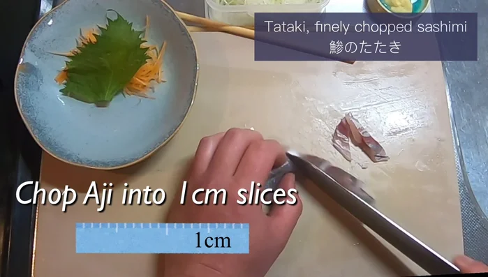Finely chop the aji into small bits, about one centimeter wide.