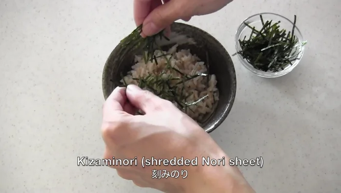 Place kizami nori on top of the rice.