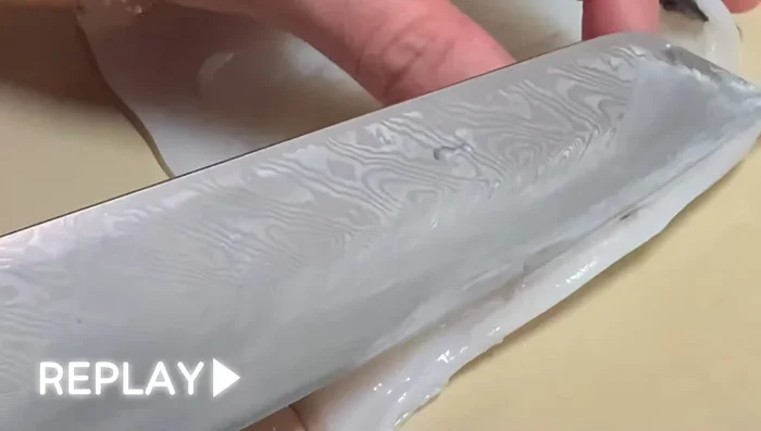 Trim the edges of the squid fillet using the Keshodji technique. Make a small slit on the bottom side of the fillet and gently peel off a thin film of skin.