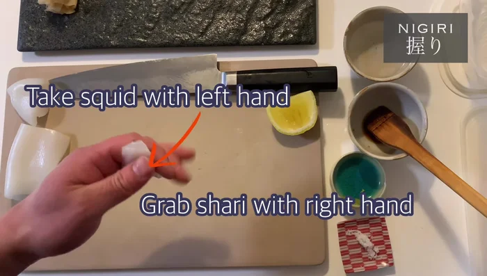 Prepare the sushi: Wet your hands with vinegar. Place a small amount of wasabi on your forefinger. Gently place a portion of shari (sushi rice) onto the squid. Spread the shallots on top and shape the sushi using your fingers.