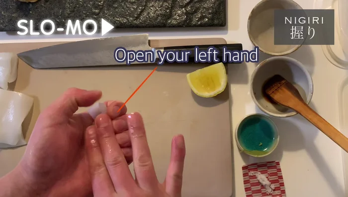 Rotate the sushi 180 degrees and repeat the shaping process. Roll it so the rice is at the bottom. Gently press and shape the sushi.
