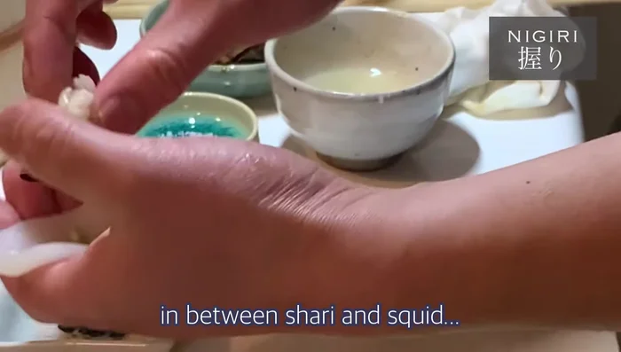 (Optional) For a more elaborate version, add nori seaweed and uni (sea urchin) between the shari and squid.