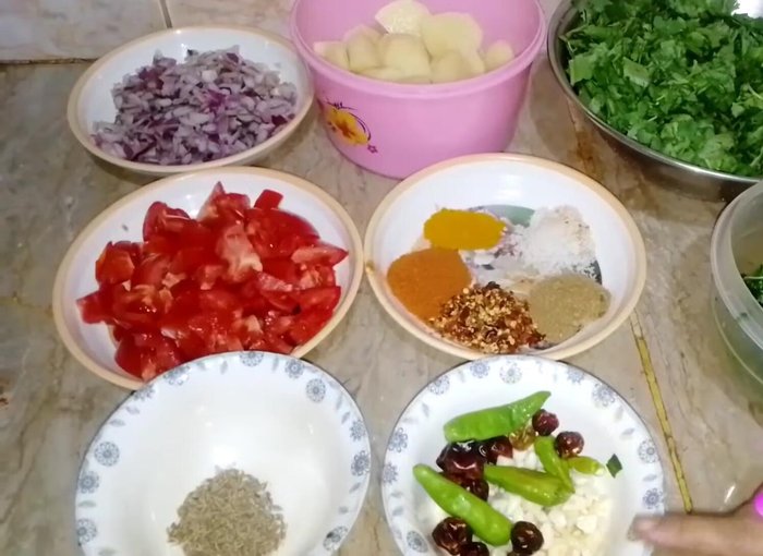 Chop spinach, potatoes, onion, and tomatoes.
