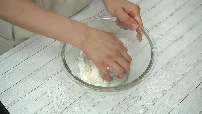 Once combined, knead the dough with your hands until smooth and no longer crumbly. Adjust with more milk if too dry, or more flour if too sticky.