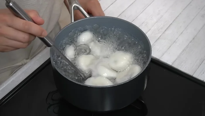 Remove the mochi balls from the boiling water and immediately transfer them to the ice water to prevent sticking.