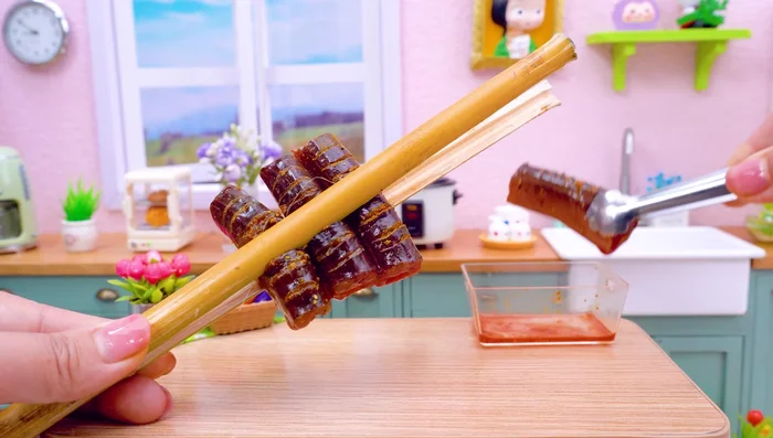 Grill the eel using bamboo tongs.