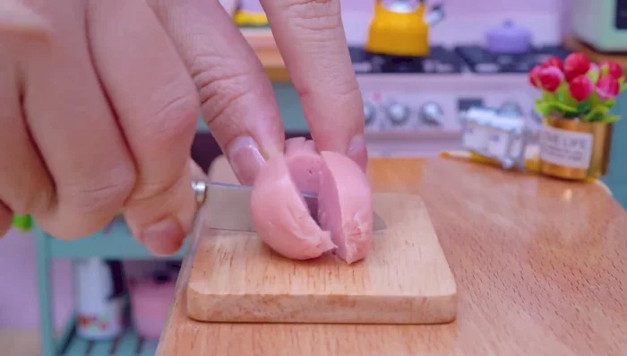 Cut sausages and cheese, then skewer them.