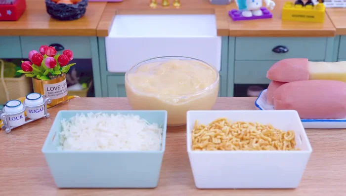 Coat sausages with crushed instant noodles and breadcrumbs.