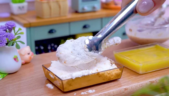 Coat chicken thigh with flour, egg mixture, and fry.