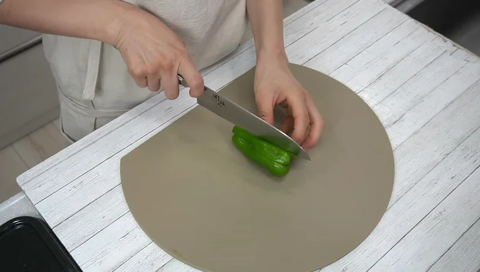 Cut the bell peppers in half, remove stems and seeds, then cut into small pieces.