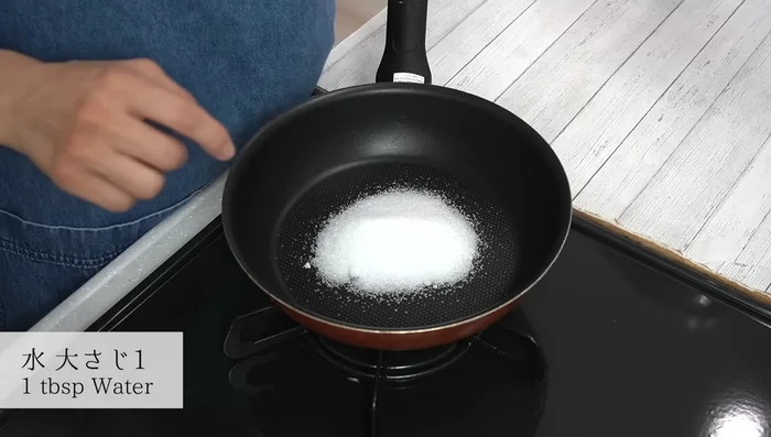 Make the caramel sauce: Add granulated sugar to a frying pan. Pour water, aiming at the sugar, and wait until absorbed. Heat on medium heat until edges slightly change color. Lift the pan and swirl to evenly distribute the color. Continue heating, stirring occasionally, until light caramel color. Reduce heat to low and finish with residual heat. Add hot water, cover to prevent splashing, and shake gently. Let it settle.