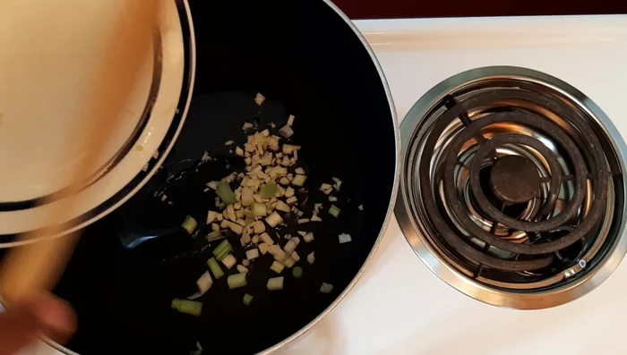 Add chopped spring onions and garlic to the pot. Sauté for about 30 seconds until fragrant, but avoid burning.