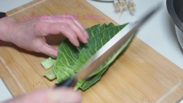 Finely mince the vegetables: two large cabbage leaves, mint (including stems), one clove of garlic, and three large spring onions.
