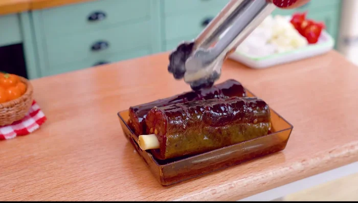 Stuff the eel: Place the lemongrass inside the eel's belly. Pour the vegetable mixture into the eel.