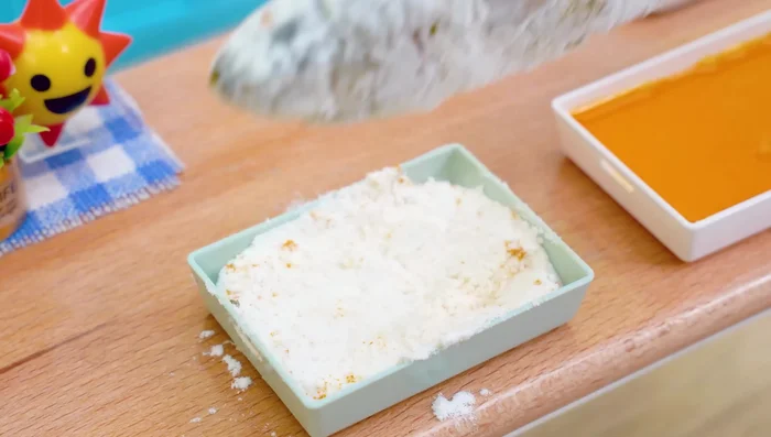 Bread the fish: coat with flour, egg, and batter, and then fry.