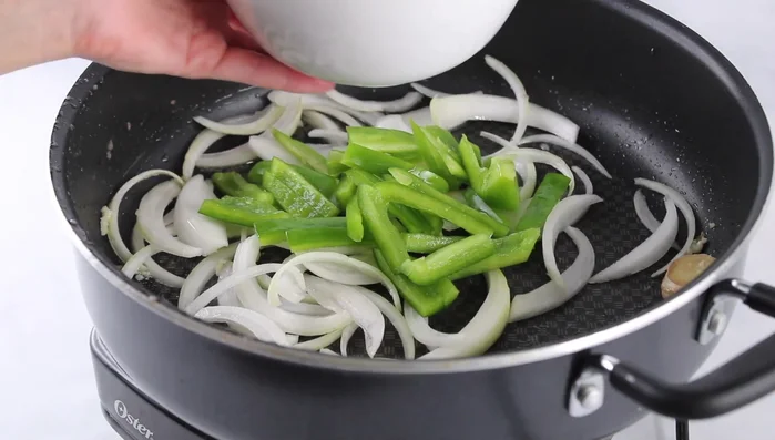 Add bell peppers and cook until onions are translucent.