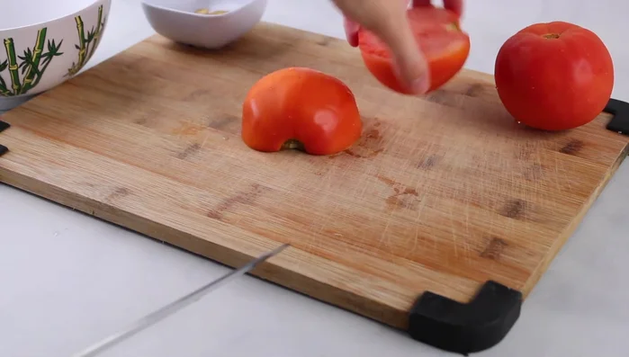 Prepare the tomatoes: Cut in half, remove the core, and cut into bite-sized pieces.