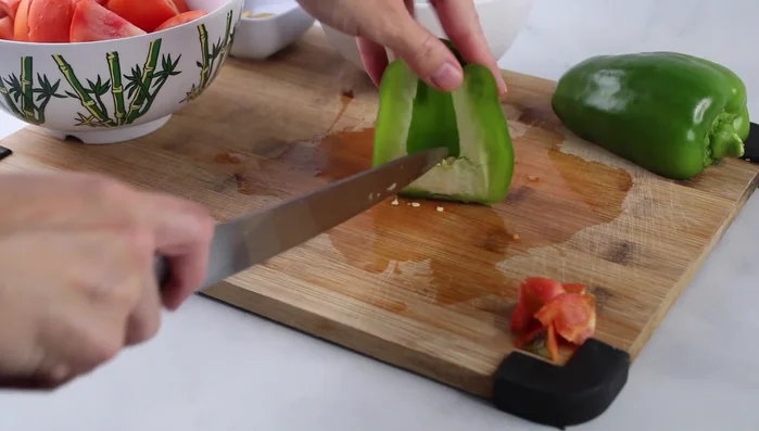 Prepare the bell pepper: Remove seeds and thinly slice, then cut into smaller pieces.