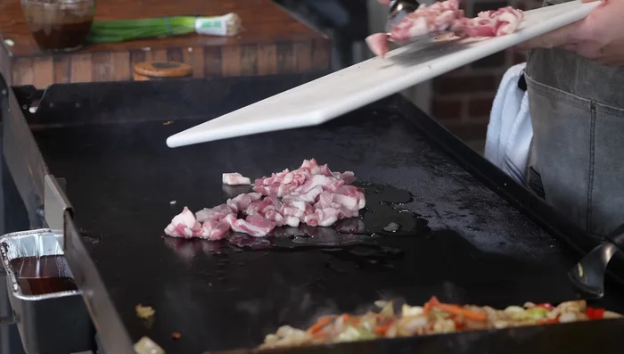 Cook the pork belly: Add pork belly to the griddle and cook until crispy, seasoning with more salt and pepper as needed.