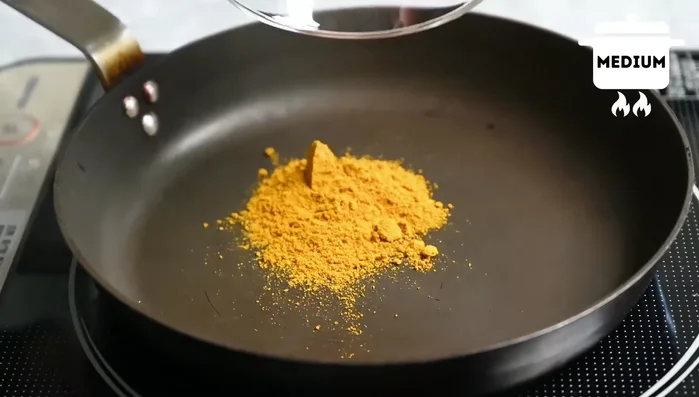 Toast curry powder and cumin in a dry frying pan until slightly darkened and smoking. Remove from heat and set aside.