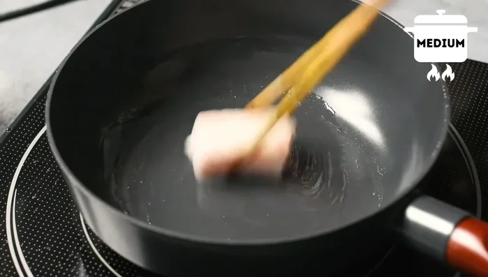 In a new pan, heat beef fat over medium heat. Add minced garlic and ginger, cook until fragrant.